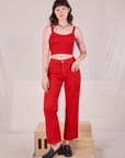 Alex is 5’8” and wearing XXS Mid-Rise Work Pants in Mustang Red paired with matching Cropped Cami