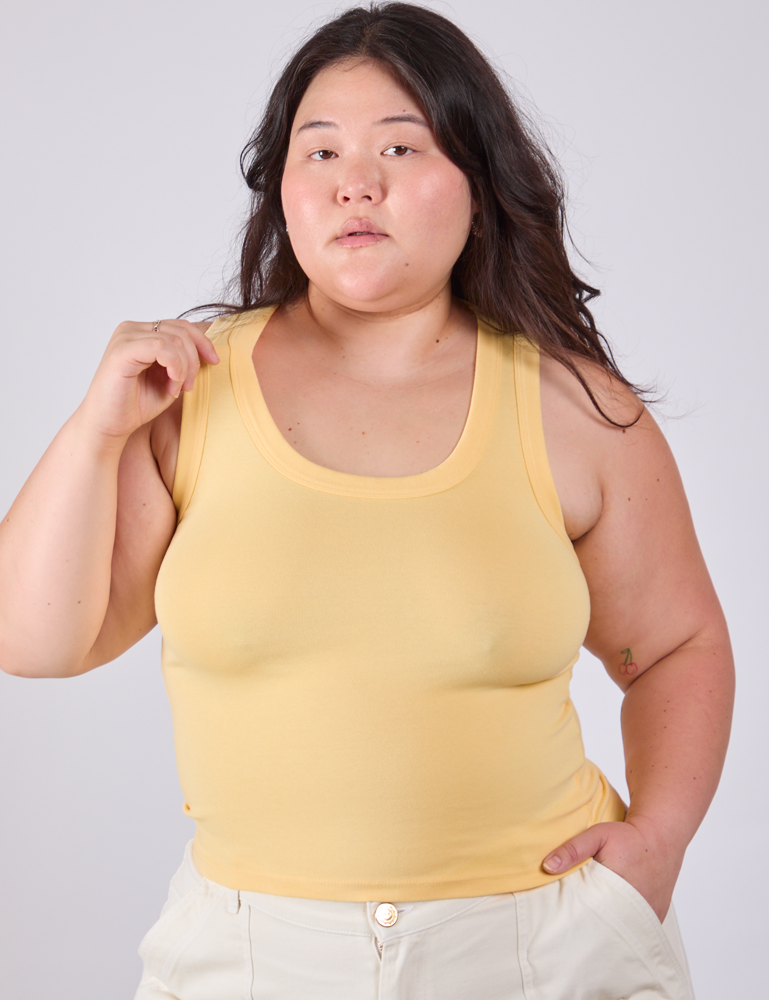 Ashley is 5'7" and wearing L Tank Top in Butter Yellow