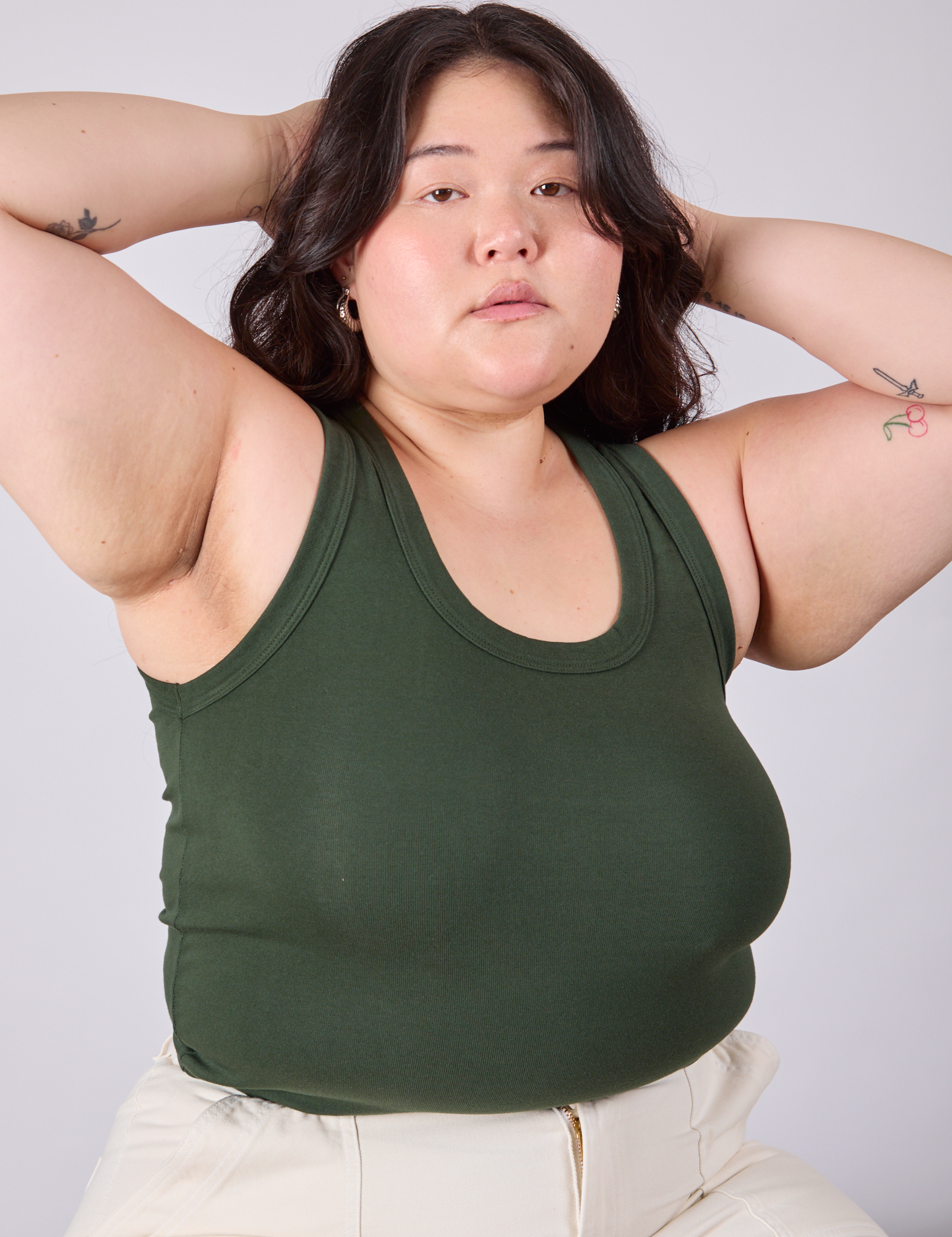 Ashley is 5'7" and wearing L Tank Top in Swamp Green