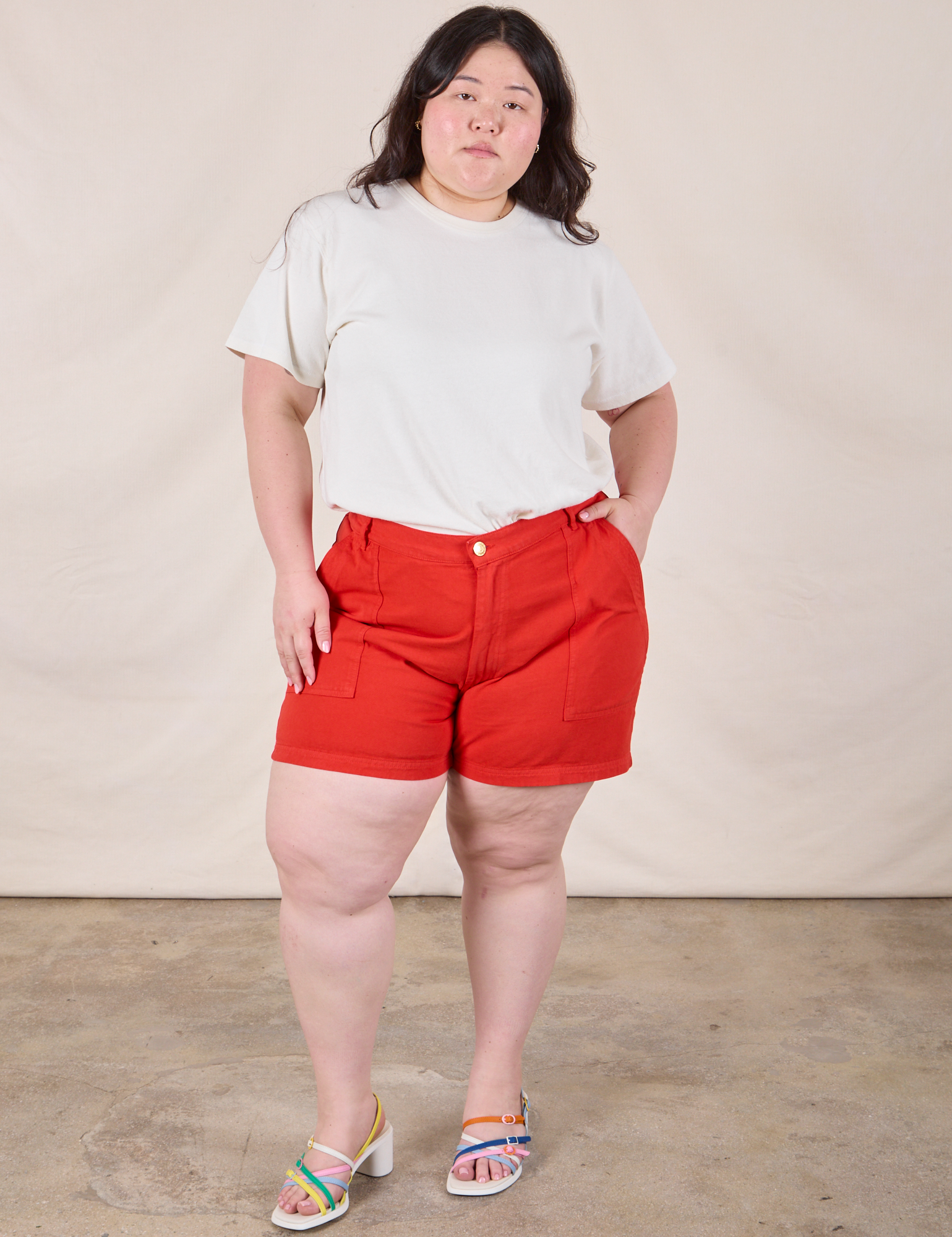 Ashley is 5’7” and wearing 1XL Classic Work Shorts in Mustang Red paired with Organic Vintage Tee in Vintage Tee Off-White