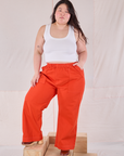 Ashley is 5'7" and wearing 1XL Action Pants in Chili Red paired with a Cropped Tank in Vintage Tee Off-White