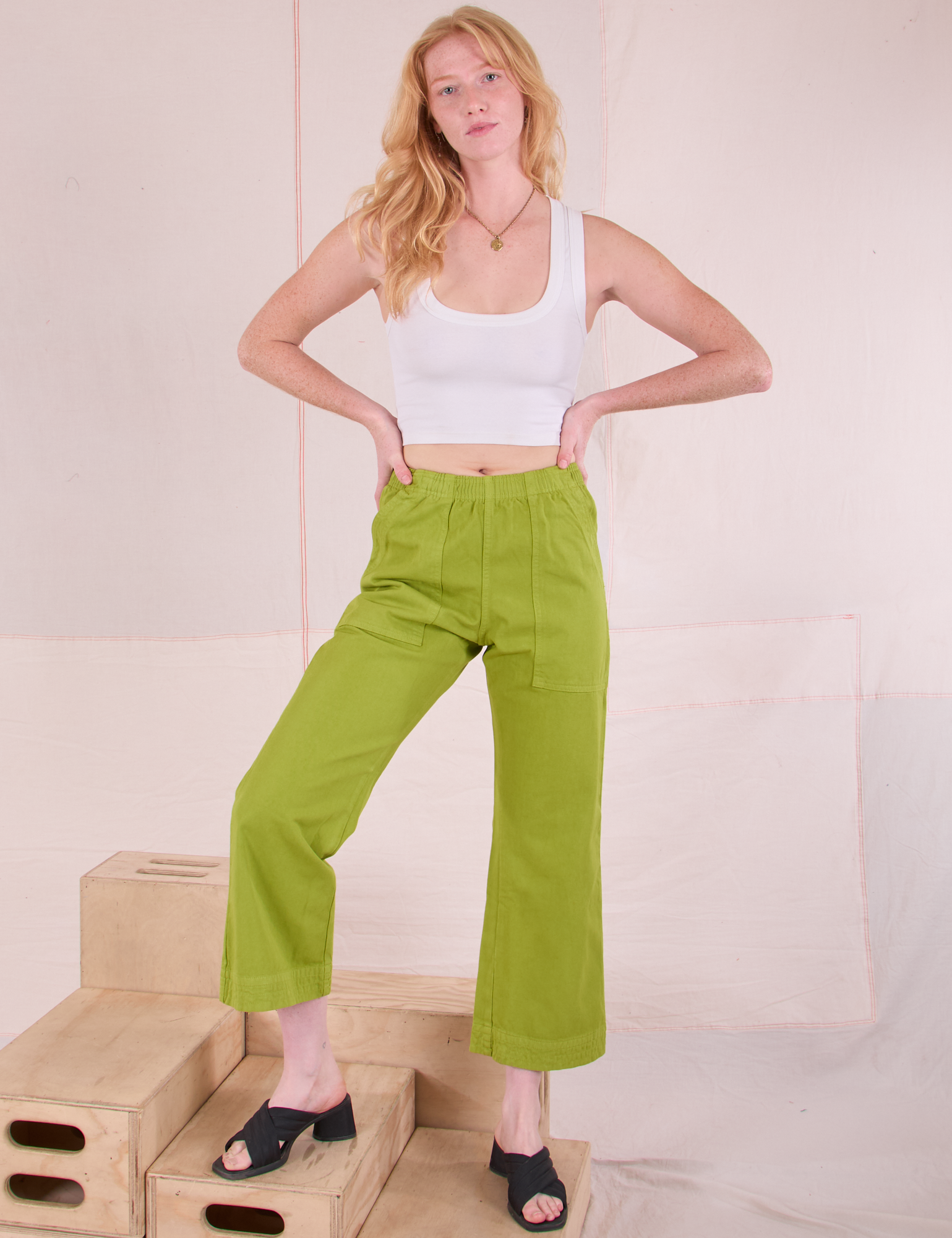 Margaret is 5'11" and wearing XXS Action Pants in Gross Green paired with a Cropped Tank in Vintage Tee Off-White