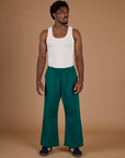 Isaac is 5'10" and wearing M Hunter Green Action Pant with the Vintage Tee Off-White Tank Top