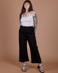 Sydney is 5’9” and wearing M Action Pants in Basic Black paired with Cropped Tank in Vintage Tee White
