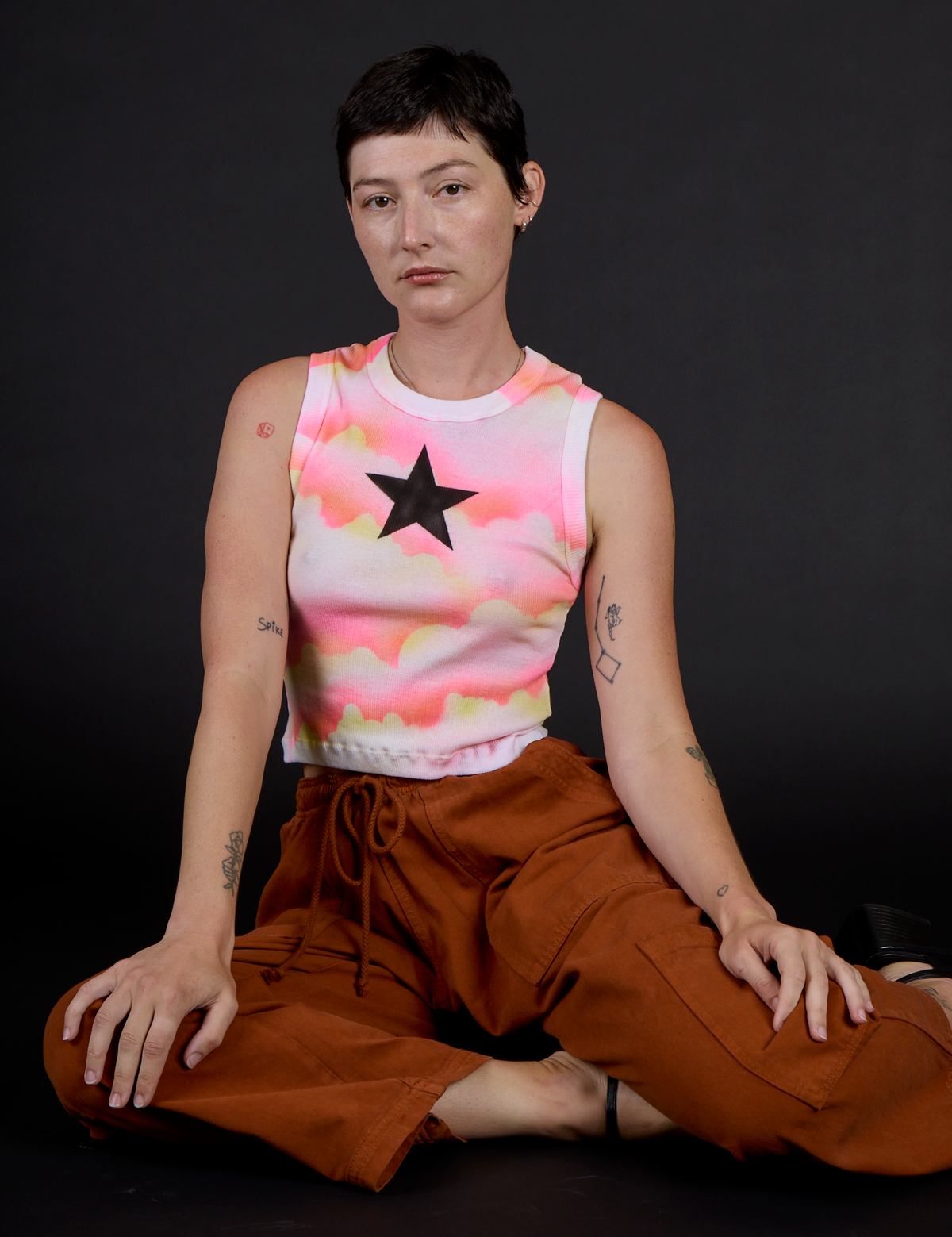 Alex is 5’8” and wearing XXS Black Star Airbrush Muscle Tee