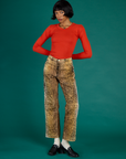 Kira is 5’10" and wearing XS Leopard Work Pants with Chili Red Long Sleeve Baby Tee