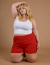 Juliet is wearing Athletic Shorts in Mustang Red and Cropped Tank in Vintage Tee White