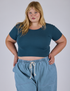 Juliet is 5’7” and wearing XL Cropped Baby Tee in Lagoon