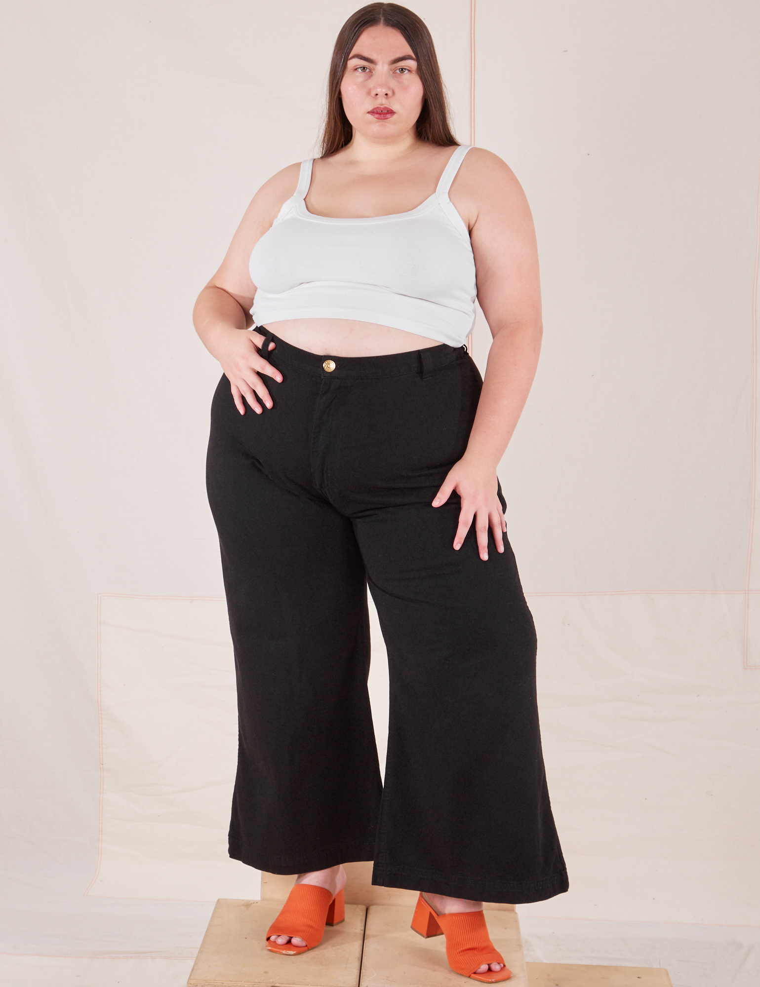 Marielena is 5'8" and wearing 2XL Bell Bottoms in Basic Black paired with vintage off-white Cami