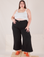 Marielena is 5'8" and wearing 2XL Bell Bottoms in Basic Black paired with a Cropped Cami in vintage tee off-white