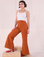 Soraya is 5'3" and wearing P Bell Bottoms in Burnt Terracotta