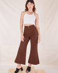 Alex is 5'8" and wearing XXS Bell Bottoms in Fudgesicle Brown paired with vintage off-white Halter Top