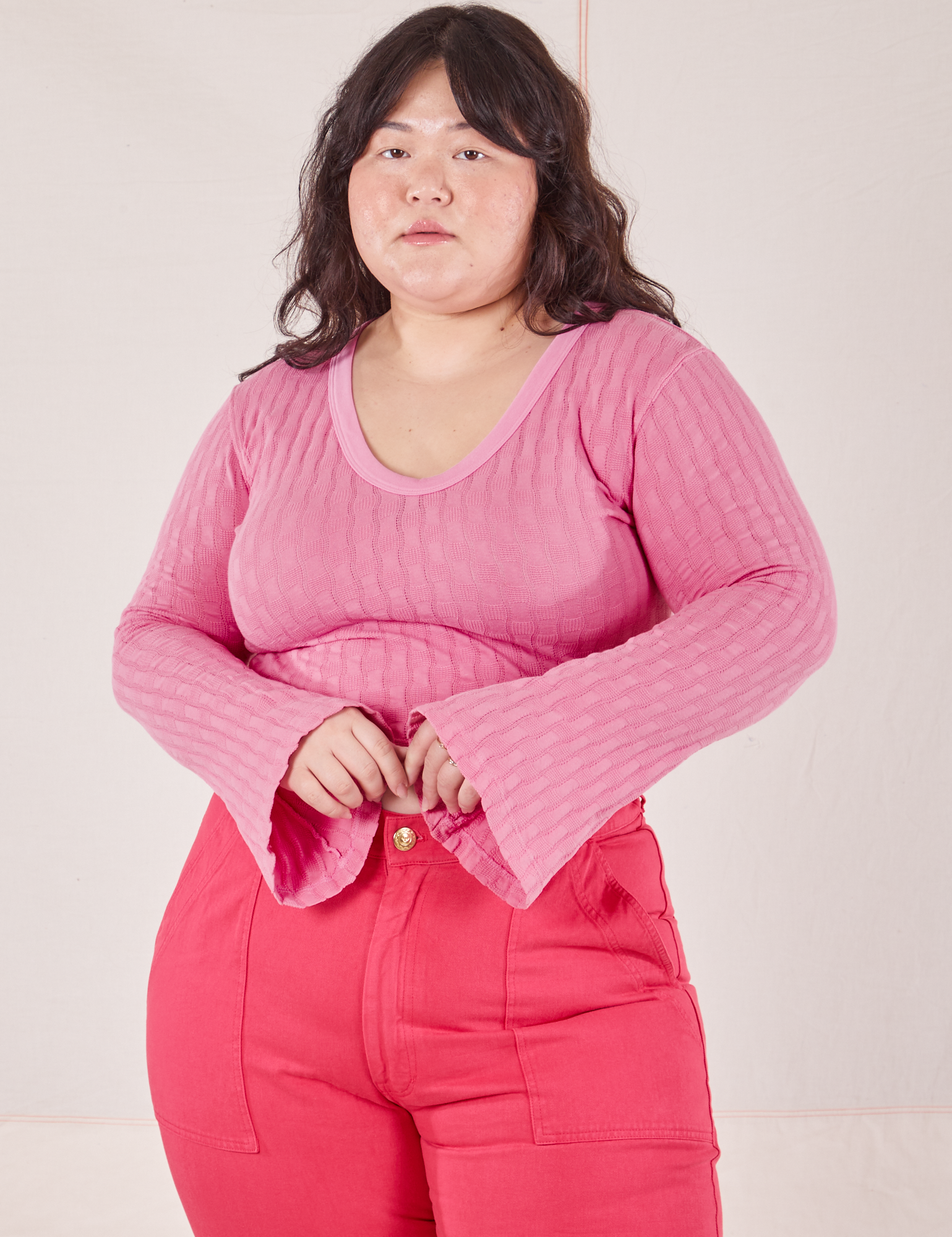 Ashley is wearing L Bell Sleeve Top in Bubblegum Pink paired with hot pink Work Pants