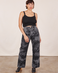 Tiara is 5'4" and wearing S Black Magic Waters Work Pants paired with black Cropped Cami