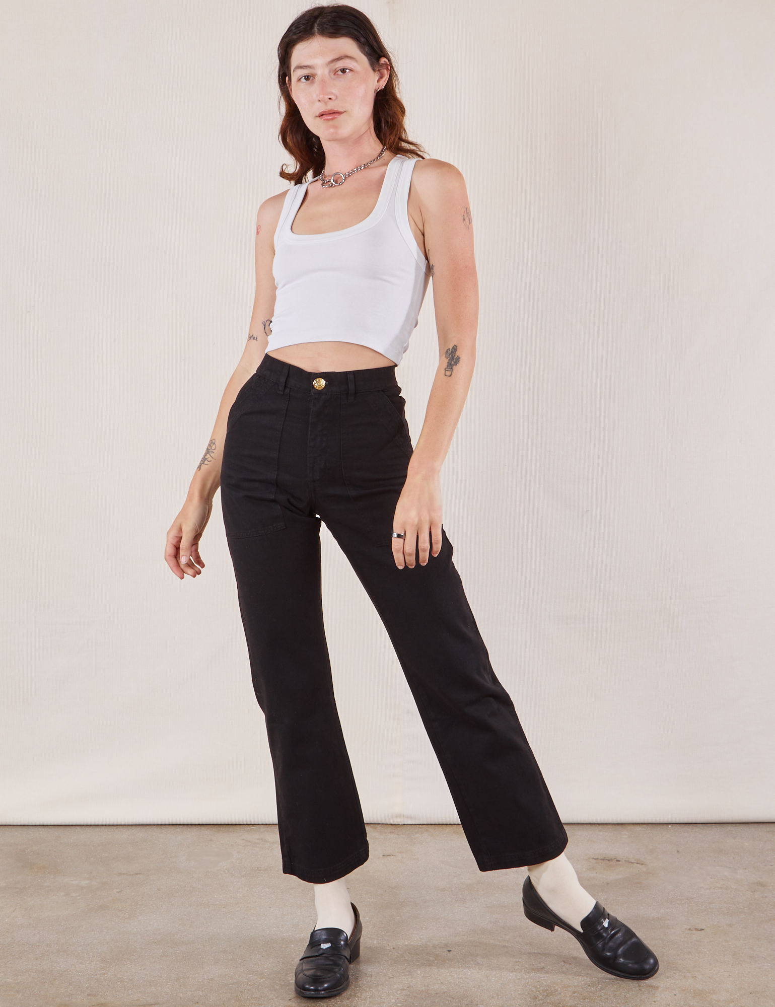 Alex is 5'8" and wearing XS Work Pants in Black paired with a Cropped Tank in vintage tee off-white