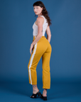 Angled back view of  Painted Work Pants in Mustard Yellow on Alex