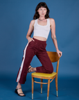 Alex is wearing Painted Action Pants in Red Wine paired with vintage tee white Cropped Tank