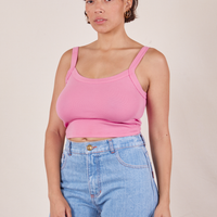 Tiara is wearing XS Cropped Cami in Bubblegum Pink paired with light wash Sailor Jeans
