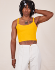 Jerrod is 6'3" and wearing S Cropped Cami in Sunshine Yellow paired with vintage off-white Western Pants