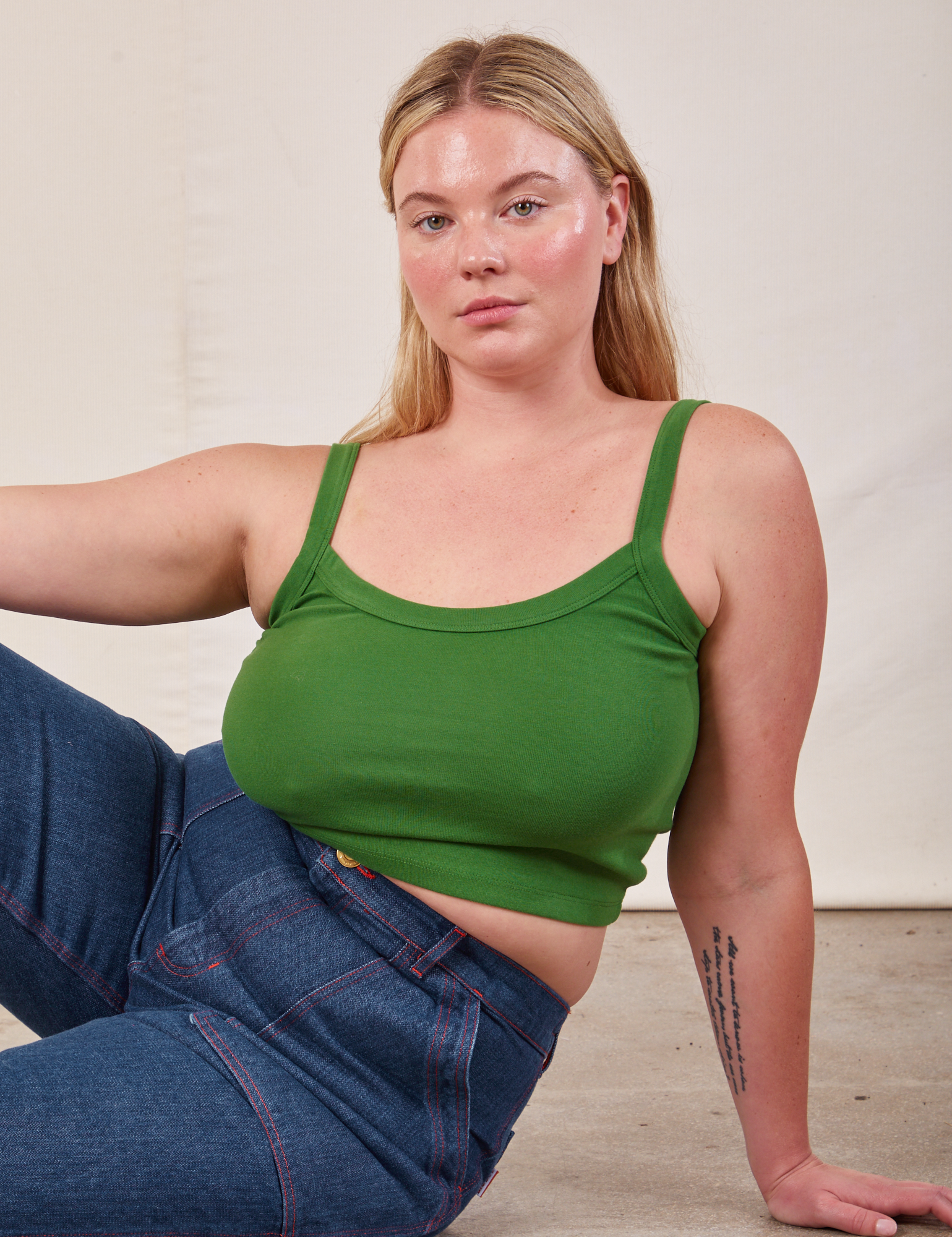 Lish is wearing Cropped Cami in Lawn Green and dark wash Carpenter Jeans