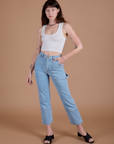 Alex is 5’8” and wearing XXS Carpenter Jeans in Light Wash and Cropped Tank in Vintage Tee Off-White