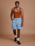 Isaac is 5’10” and wearing M Carpenter Shorts in Light Wash paired with burnt terracotta Cropped Tank