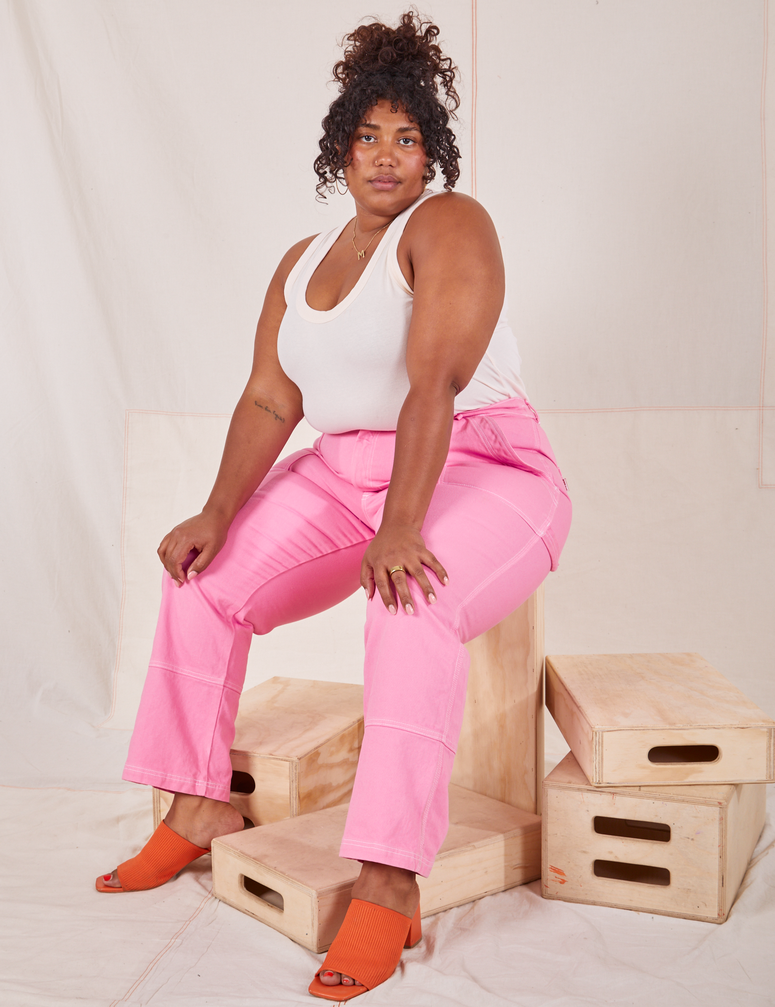Morgan is 5'5" and wearing 1XL Carpenter Jeans in Bubblegum Pink paired with vintage off-white Tank Top