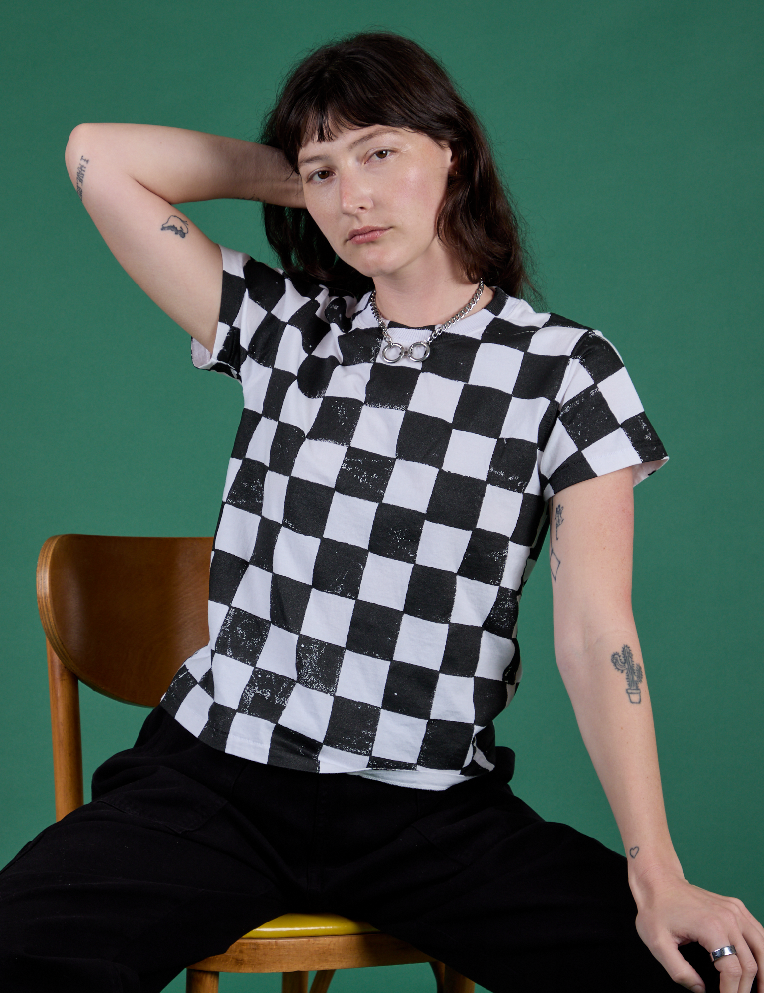 Alex is wearing Checker Organic Tee in Black
