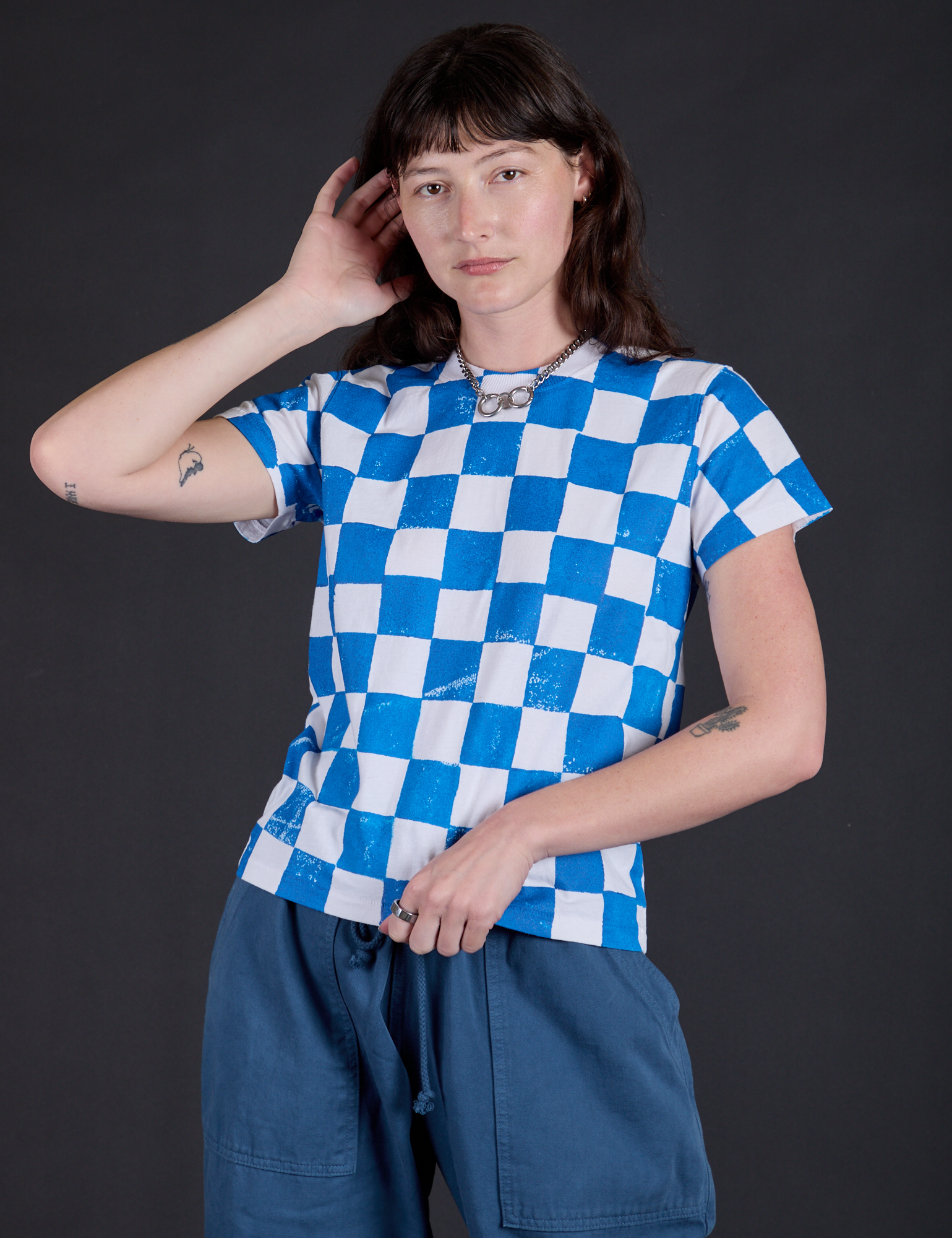 Alex is 5'8" and wearing P Checker Organic Tee in Blue