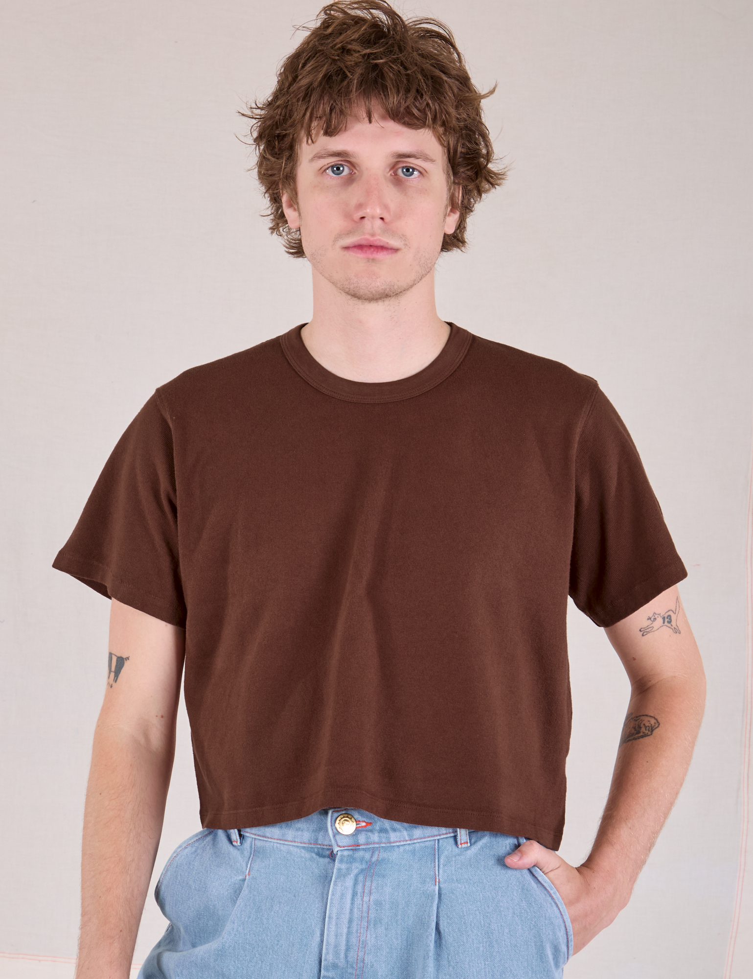 Quinn is 6'3" and wearing M Cropped Burly Tee in Fudgesicle Brown