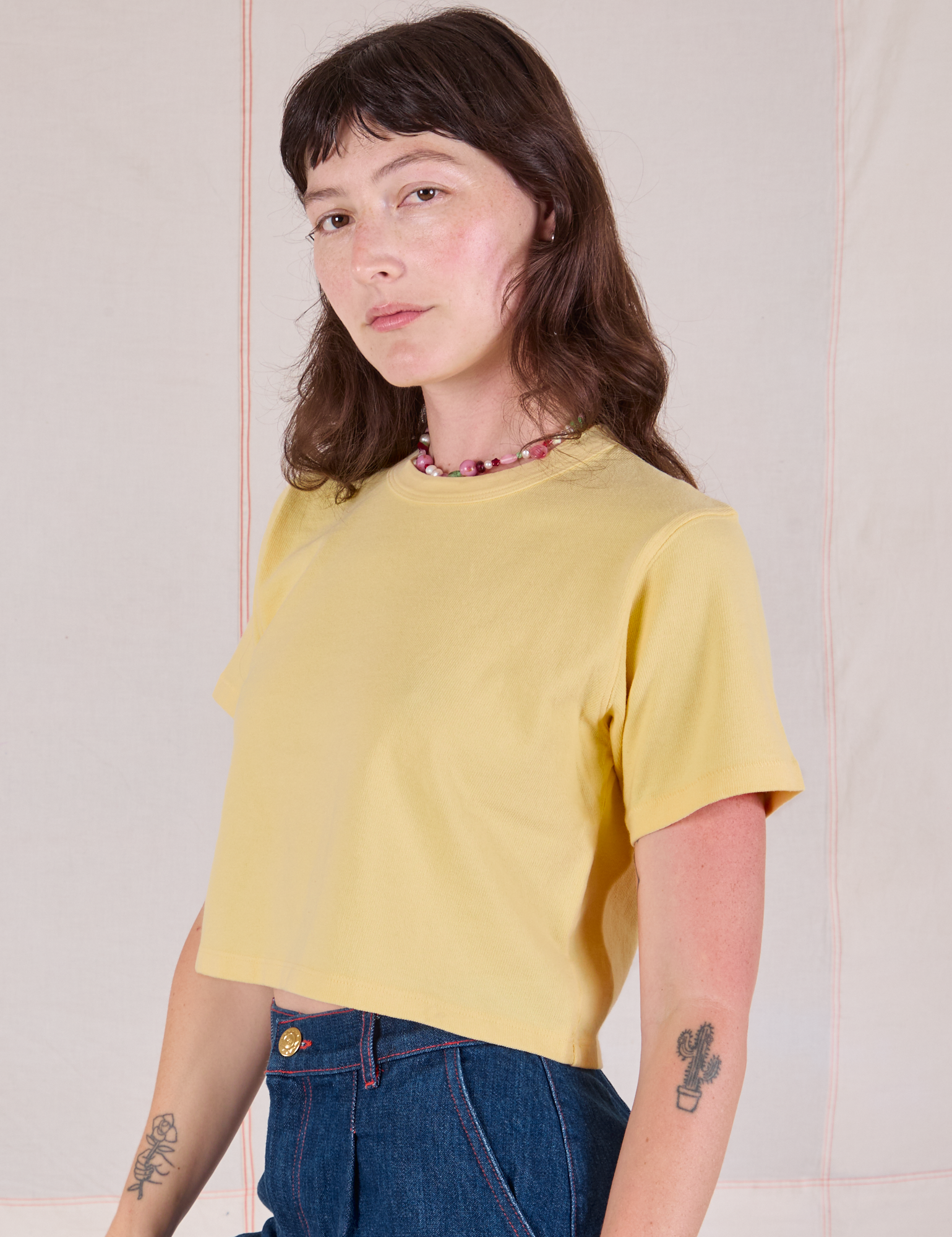 Alex is 5'8" and wearing P Cropped Burly Tee in Butter Yellow