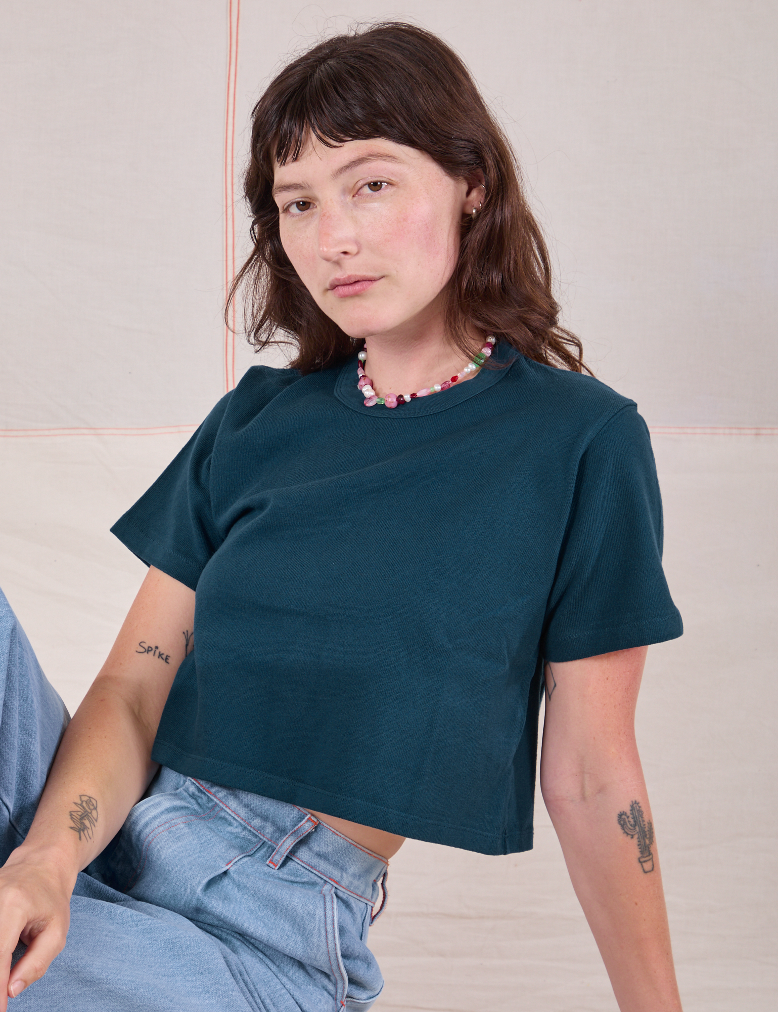Alex is 5'8" and wearing P Cropped Burly Tee in Lagoon