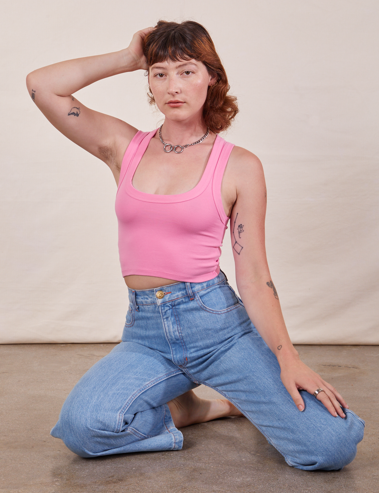 Alex is 5&#39;8&quot; and wearing P Cropped Tank Top in Bubblegum Pink paired with light wash Sailor Jeans