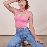 Alex is 5'8" and wearing P Cropped Tank Top in Bubblegum Pink paired with light wash Sailor Jeans