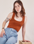 Hana is wearing Cropped Tank Top in Burnt Terracotta and light wash Carpenter Jeans