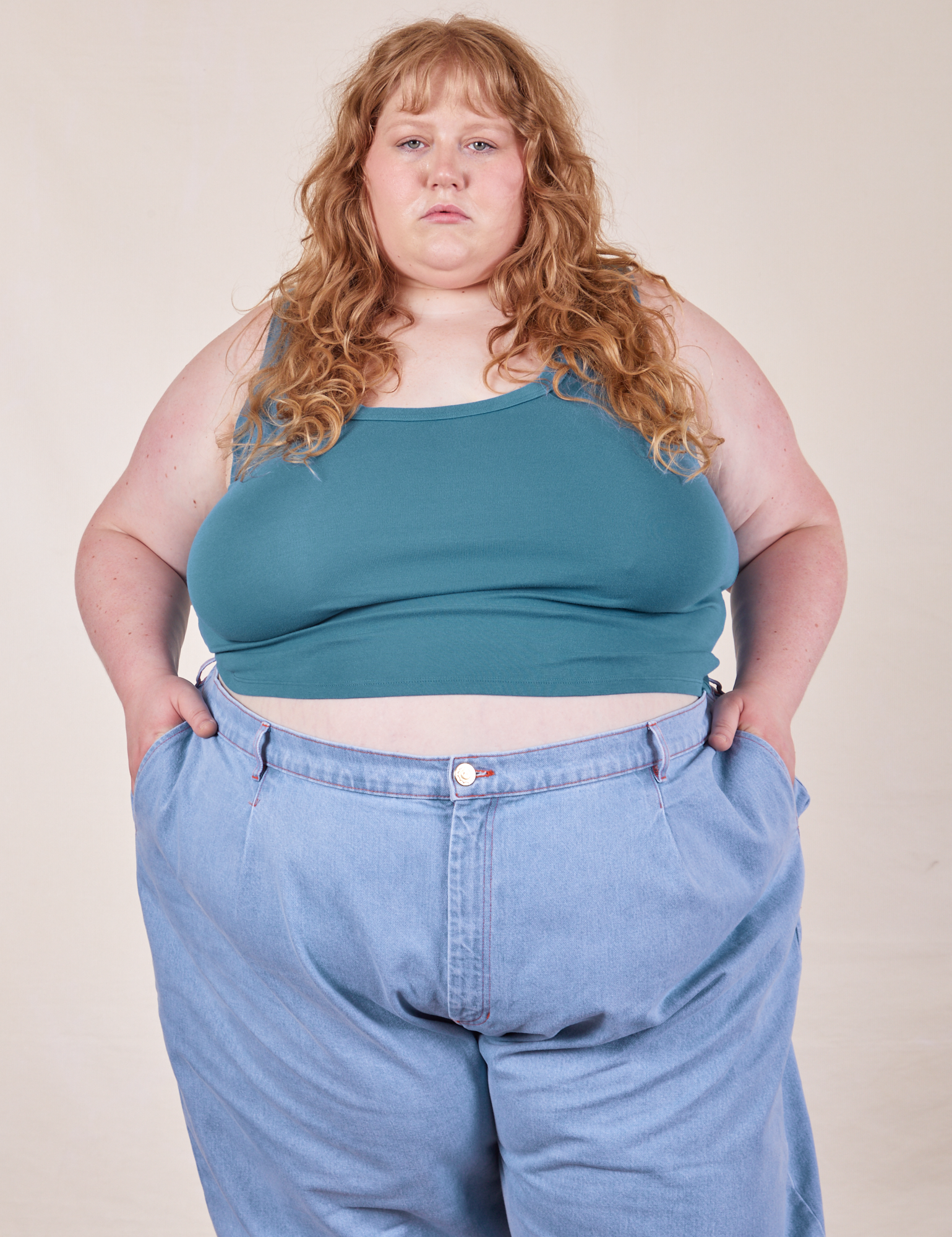 Catie is 5&#39;11&quot; and wearing 4XL Cropped Tank Top in Marine Blue