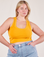 Lish is 5'8" and wearing S Cropped Tank Top in Mustard Yellow