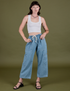 Alex is 5’8” and wearing XXS Denim Drop Pocket Pants in Light Wash paired with vintage tee white Cropped Tank