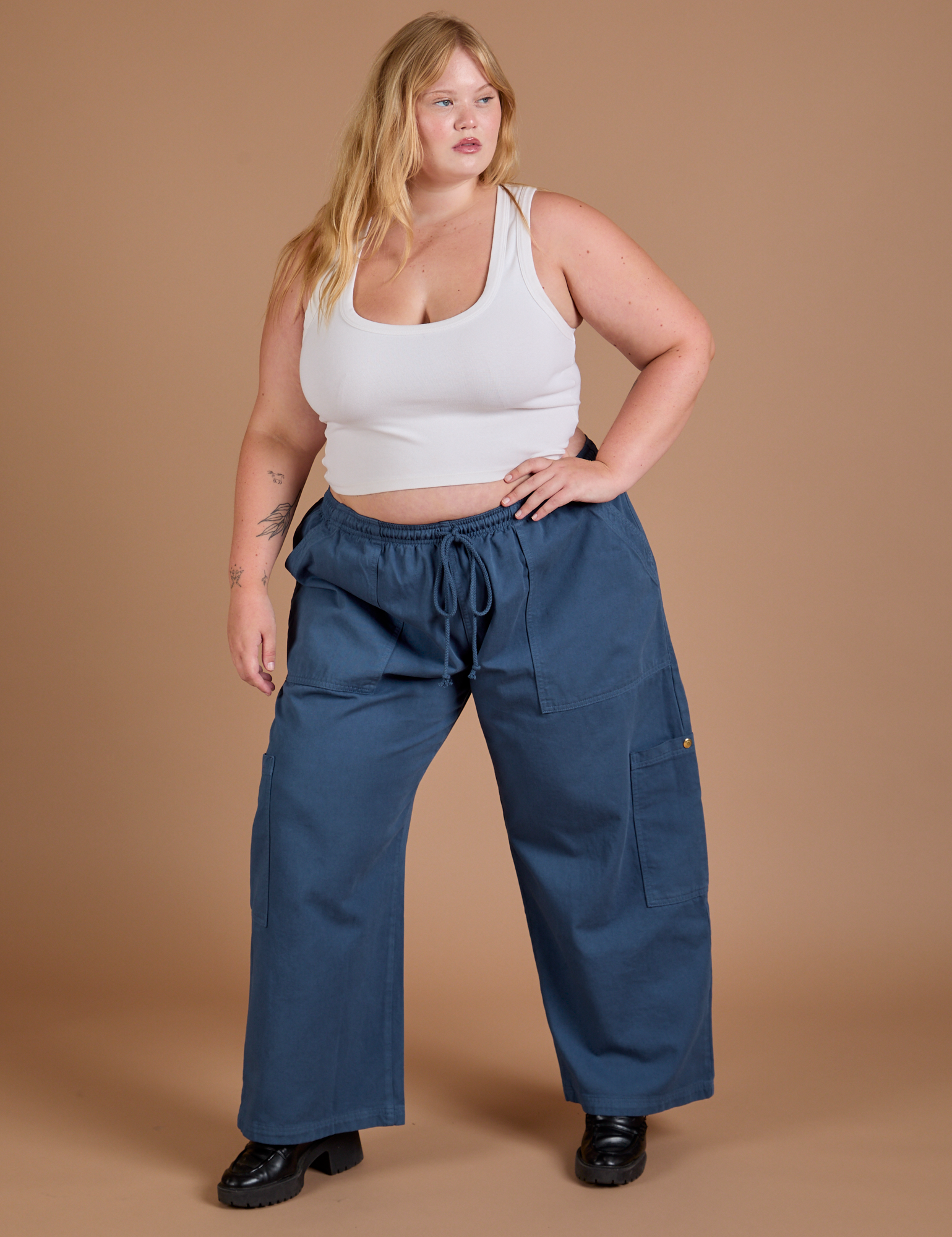 Juliet is 5’7” and wearing 1XL Drop Pocket Cargo Pants in French Blue paired with a Cropped Tank in Vintage Tee White