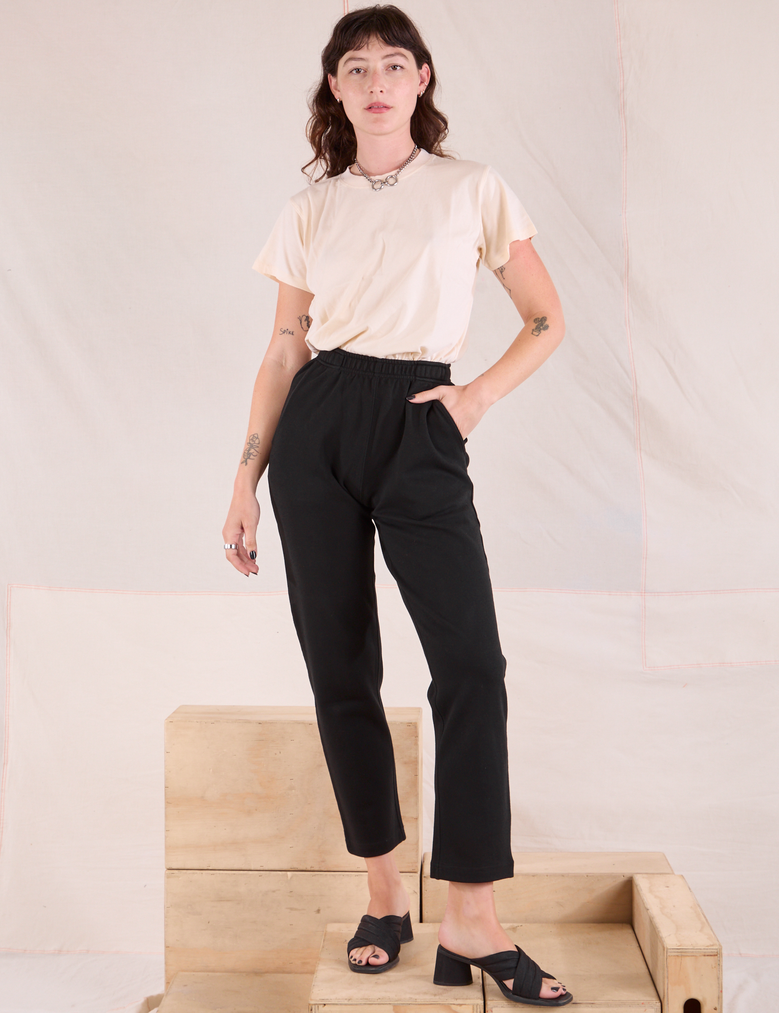 Alex is 5'8" and wearing P Easy Pants in Basic Black paired with Organic Vintage Tee Off-White in vintage tee off-white