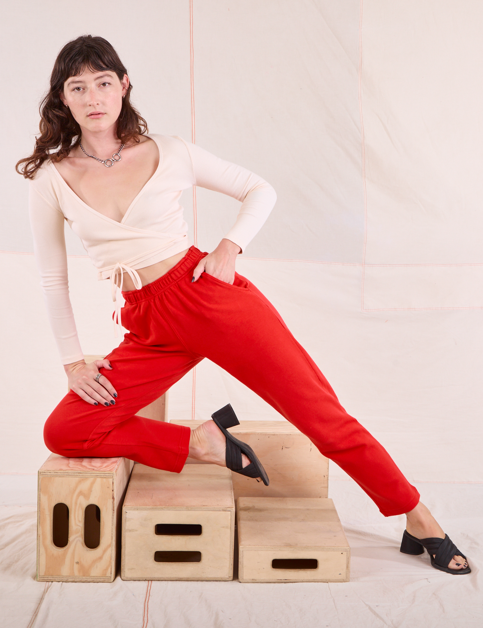 Alex is wearing Easy Pants in Mustang Red paired with vintage tee off-white Wrap Top