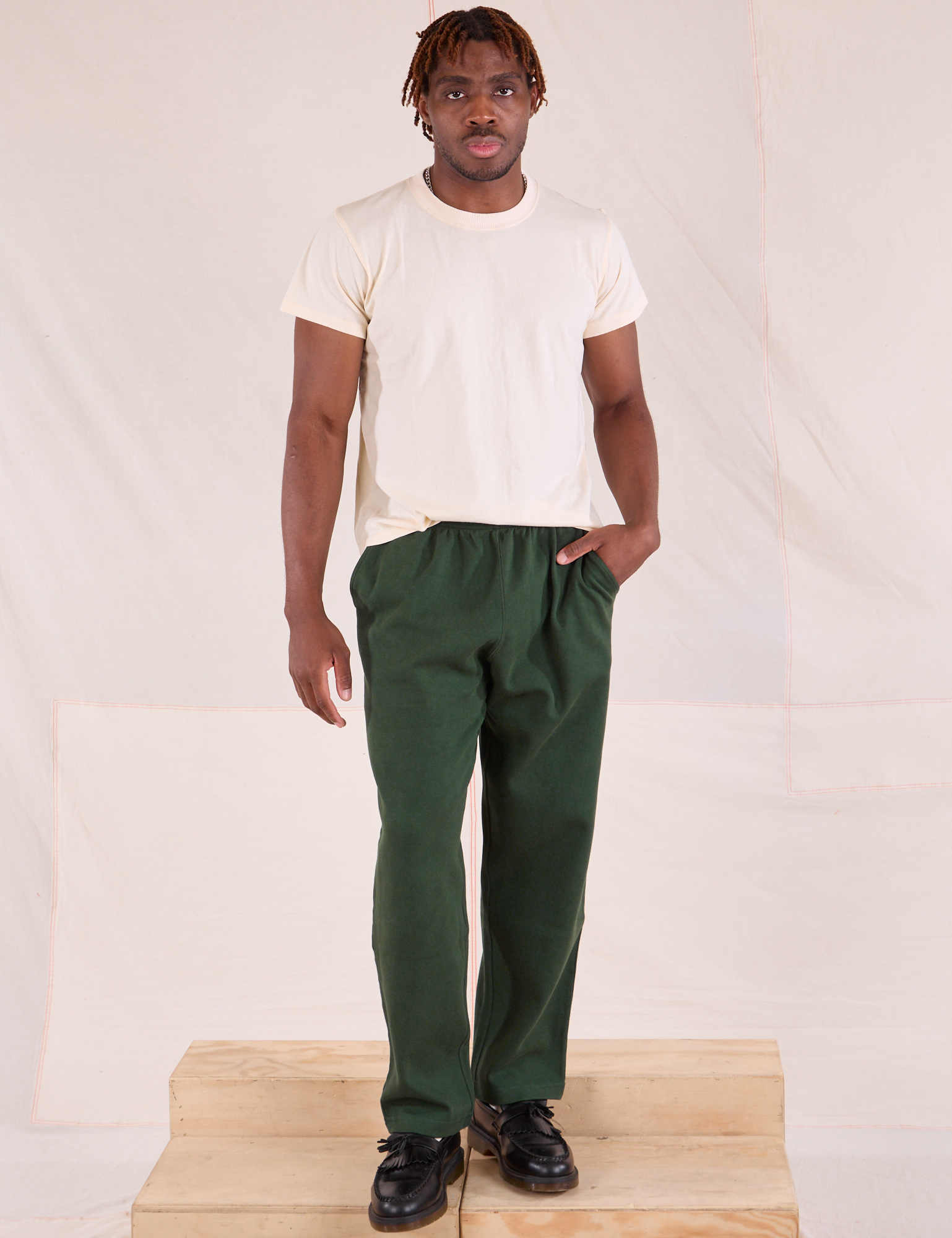 Issac is 5'10" and wearing M Easy Pants in Swamp Green paired with a Organic Tee in Vintage Tee Off-White