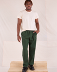 Issac is 5'10" and wearing M Easy Pants in Swamp Green paired with a Organic Tee in Vintage Tee Off-White