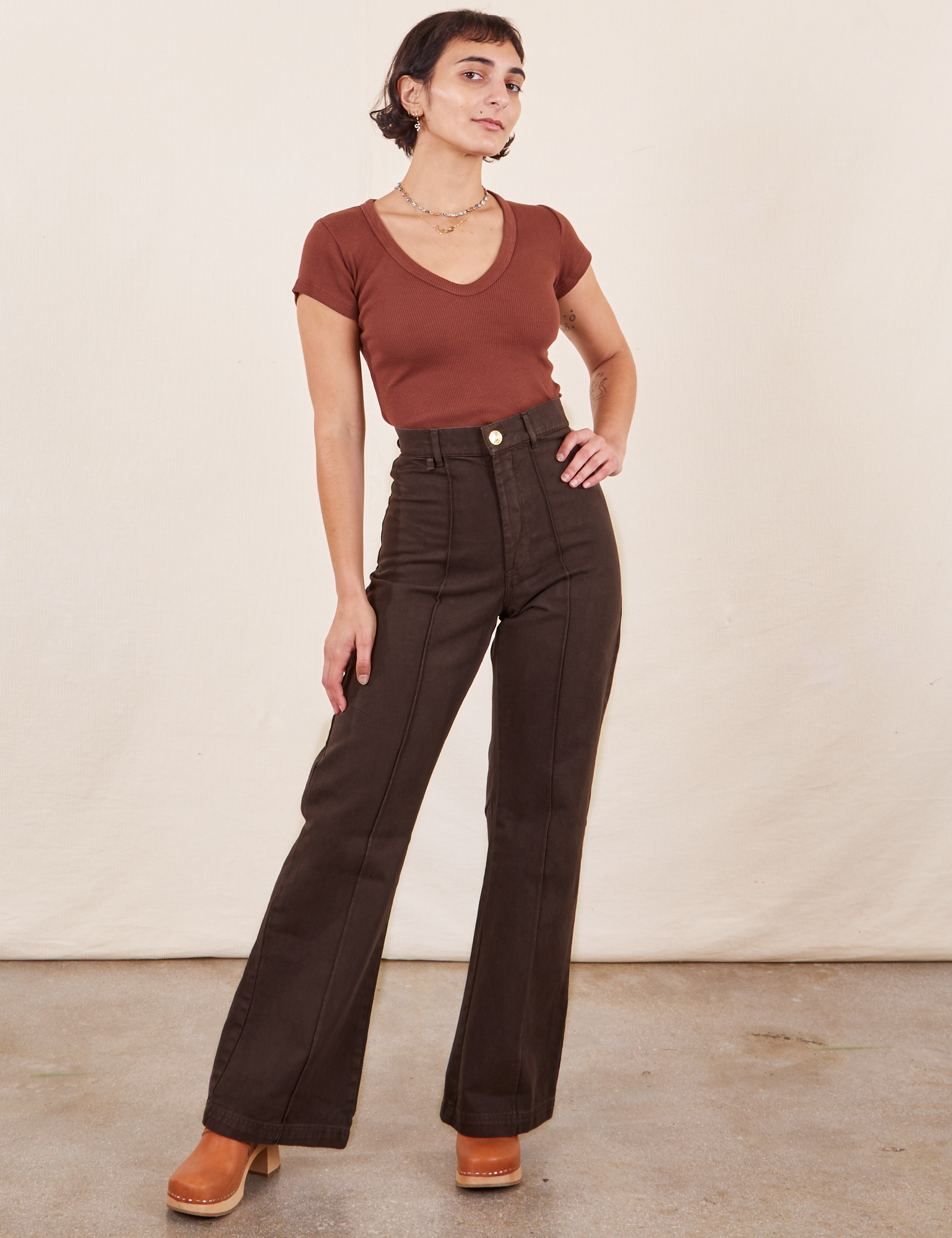 Soraya is 5&#39;2&quot; and wearing XXS Petite Western Pants in Espresso Brown paired with fudgesicle brown V-Neck Tee