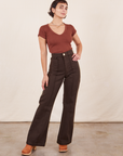 Soraya is 5'2" and wearing XXS Petite Western Pants in Espresso Brown paired with fudgesicle brown V-Neck Tee