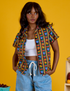 Kandia is 5’3” and wearing XXS Fruit Fantasy Pantry Button-Up and Light Wash Drop Pocket jeans
