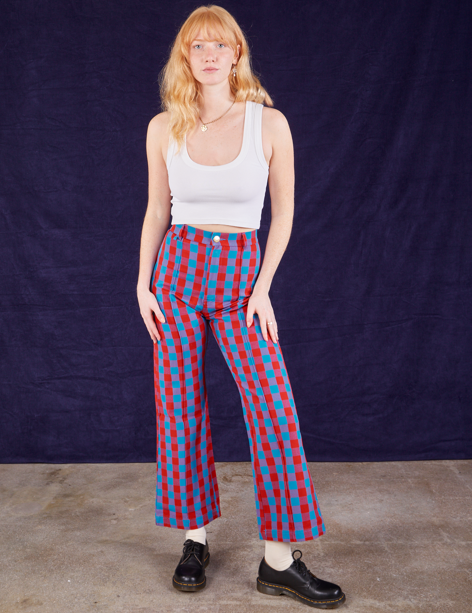 Margaret is 5'11" and wearing XS Gingham Western Pants in Blue & Red paired with a Cropped Tank in vintage tee off-white