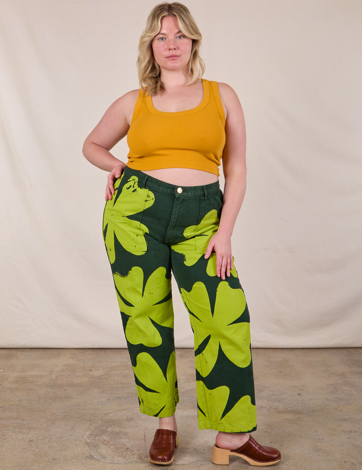 Lish is 5'8" and wearing XL Paintstamped Clover Work Pant paired with a Mustard Yellow Cropped Tank