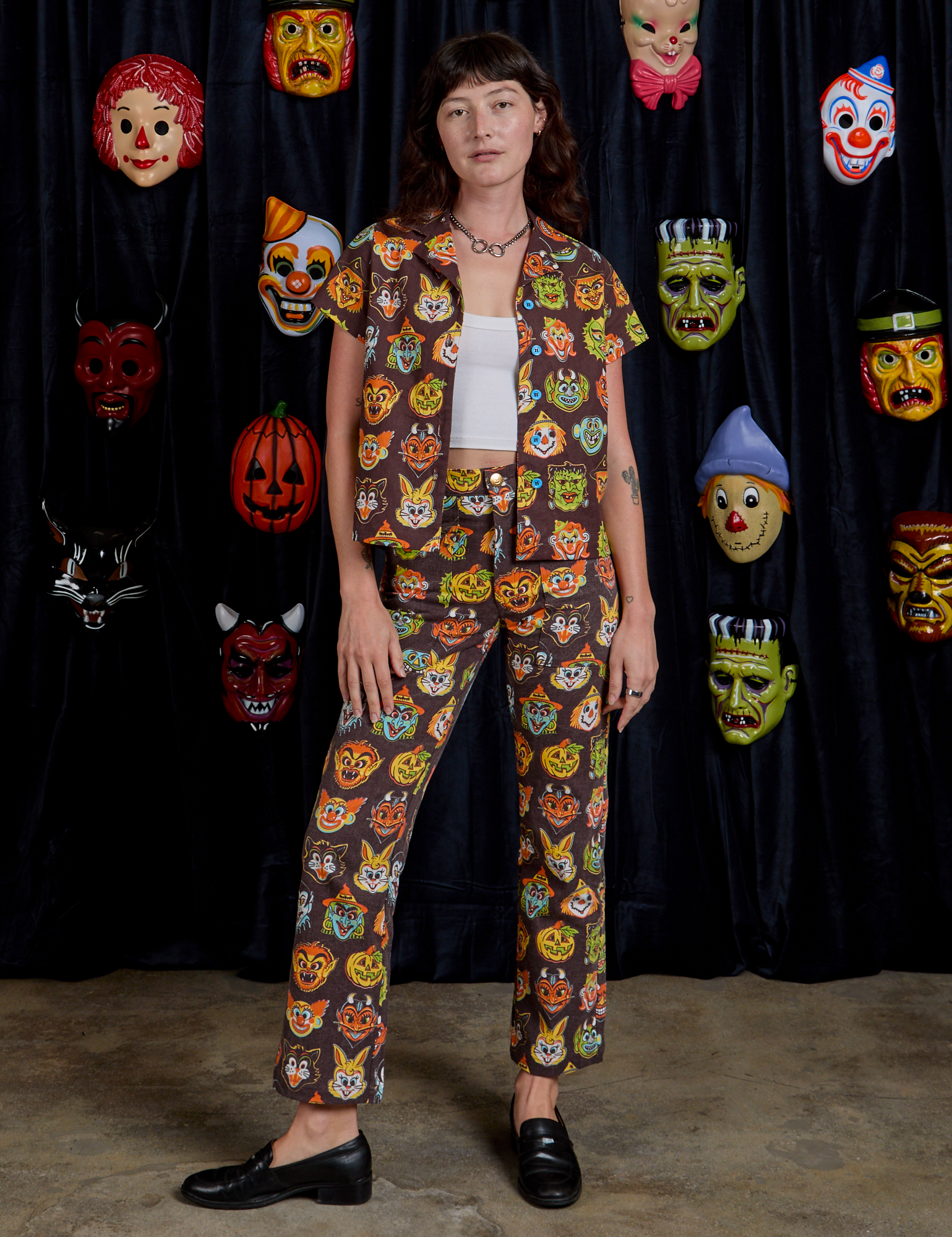Alex is is 5&#39;8&quot; and wearing XXS Work Pants in Halloween Masks paired with matching Pantry Button-Up