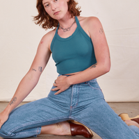 Alex is 5'8" and wearing P Halter Top in Marine Blue paired with light wash Frontier Jeans